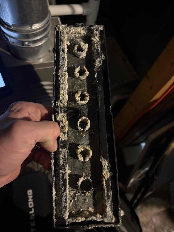 Responded to no heat call and identified severely restricted airflow due to heavily clogged filter/component with extensive dust and lint accumulation. Removed and cleaned the obstructed component, inspected the interior compartment for proper operation, and verified system functionality before completing service.
