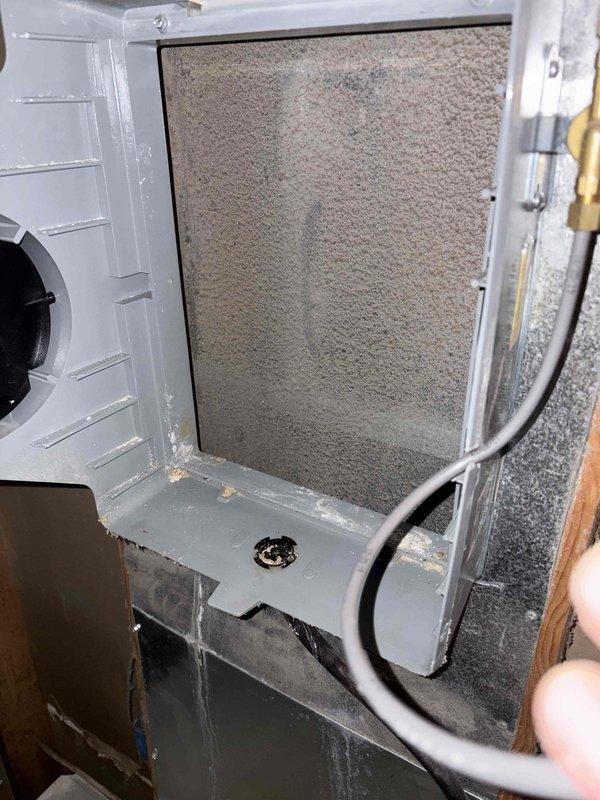 Responded to no heat call and identified severely restricted airflow due to heavily clogged filter/component with extensive dust and lint accumulation. Removed and cleaned the obstructed component, inspected the interior compartment for proper operation, and verified system functionality before completing service.