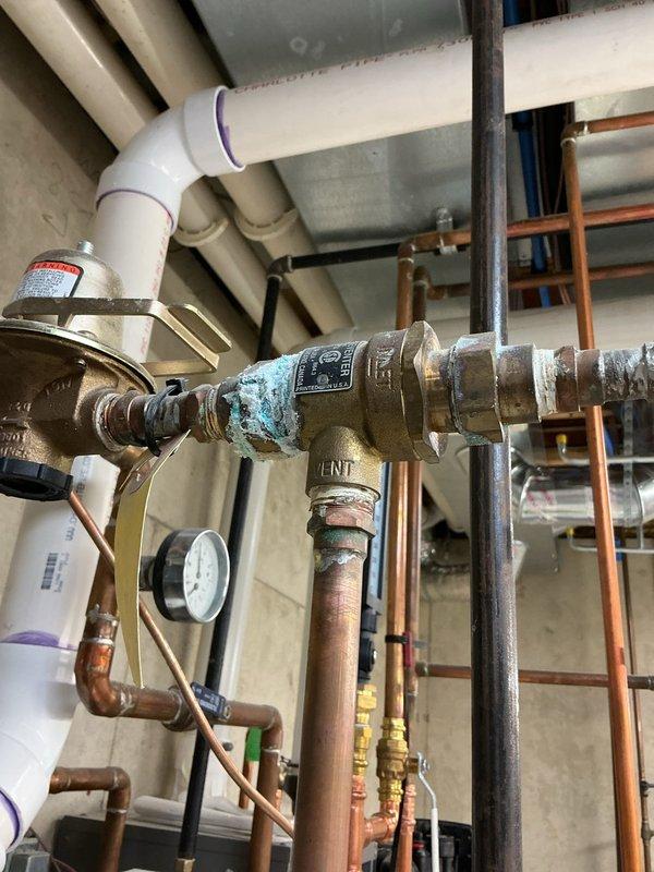 Performed complimentary annual boiler tune-up service on 0-year-old unit equipped with humidifier. Visual inspection revealed significant corrosion on brass valve/regulator components within the water distribution system and evidence of rust formation on HVAC ductwork. Completed standard maintenance procedures and documented system condition with photographs for service records.