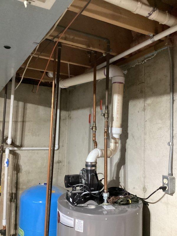 Responded to service call for 9-year-old Rheem water heater leaking from the top area while still providing hot water. Upon inspection, identified deteriorated fittings at the cold water inlet connection as the source of the leak. Replaced affected fittings and performed pressure test to confirm repair was successful, restoring system to proper operation with no further leakage.