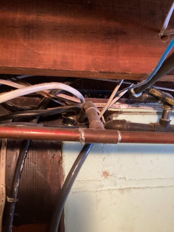 Conducted site assessment for client requesting installation of grab bars, Toto Drake toilet installation, reinstallation of toilet seat with riser, and tankless water heater system. Inspection of basement revealed aging copper plumbing infrastructure with evidence of moisture issues on concrete block walls, and evaluation of existing plumbing connections for compatibility with requested on-demand water heating system.