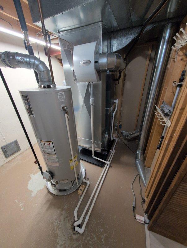 Successfully installed new furnace unit in basement utility room, connecting to existing ductwork and ensuring proper PVC venting. System includes integration with water heater and all connections were verified functional with no issues.