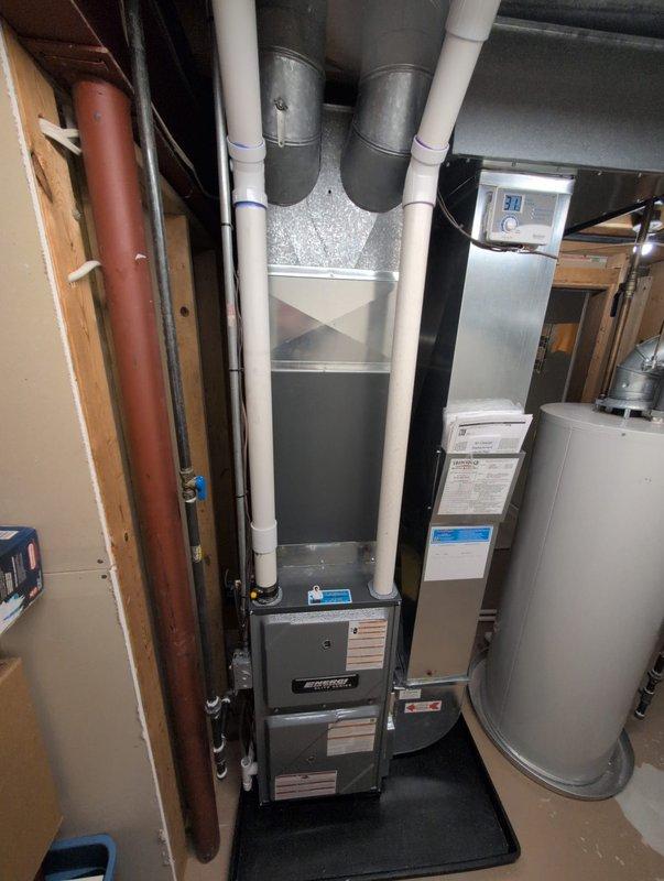 Successfully installed new furnace unit in basement utility room, connecting to existing ductwork and ensuring proper PVC venting. System includes integration with water heater and all connections were verified functional with no issues.