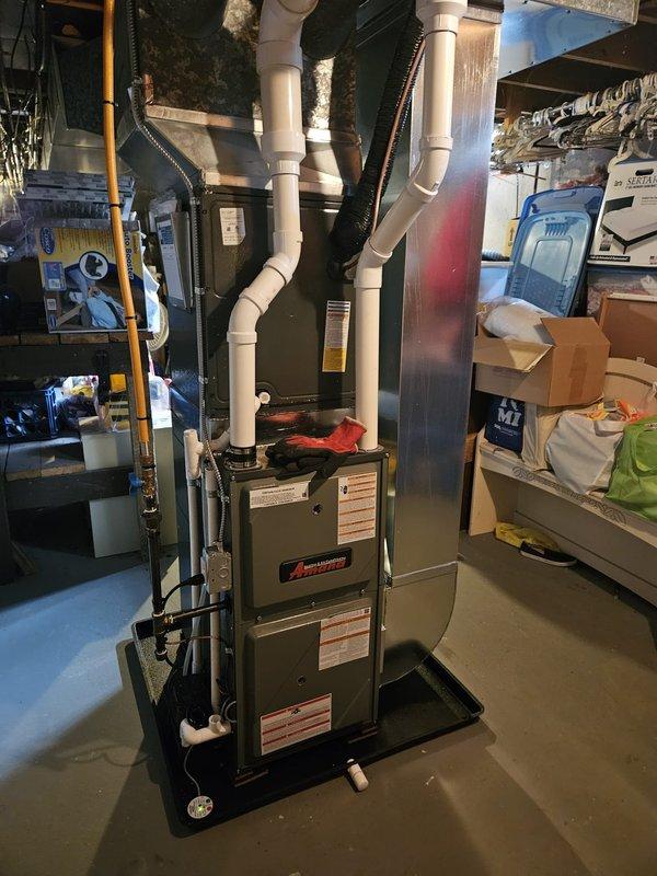 Successfully installed new Ameristar furnace with proper PVC venting system and drain pan in basement mechanical room, along with replacement water heater featuring appropriate piping connections. Both units were properly connected to existing ductwork and plumbing systems, with all safety checks completed and system functionality verified.