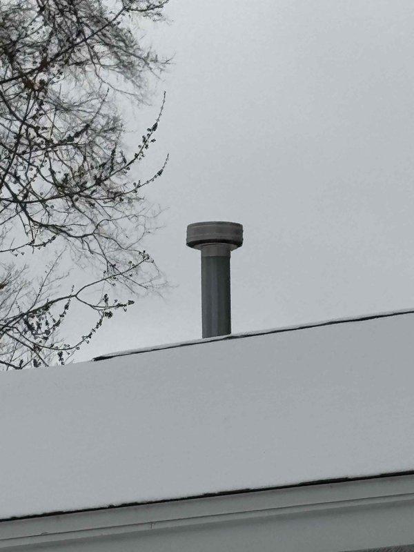 Completed installation of a new water heater in basement utility room, including proper connection of copper supply lines and installation of metal ventilation piping. Verified proper venting through roof-mounted chimney stack to ensure safe exhaust discharge and system functionality.