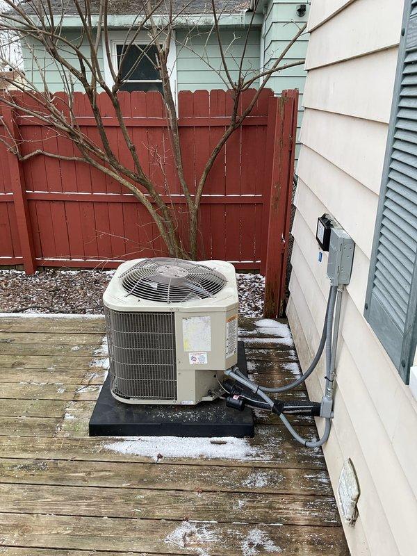 Responded to no-cooling service call to find outdoor AC unit severely damaged by fallen icicle. Unit installed on wooden deck showed visible frost accumulation on components. After thorough inspection, determined unit requires replacement rather than repair due to extent of damage. Documented condition with photos for insurance claim purposes.