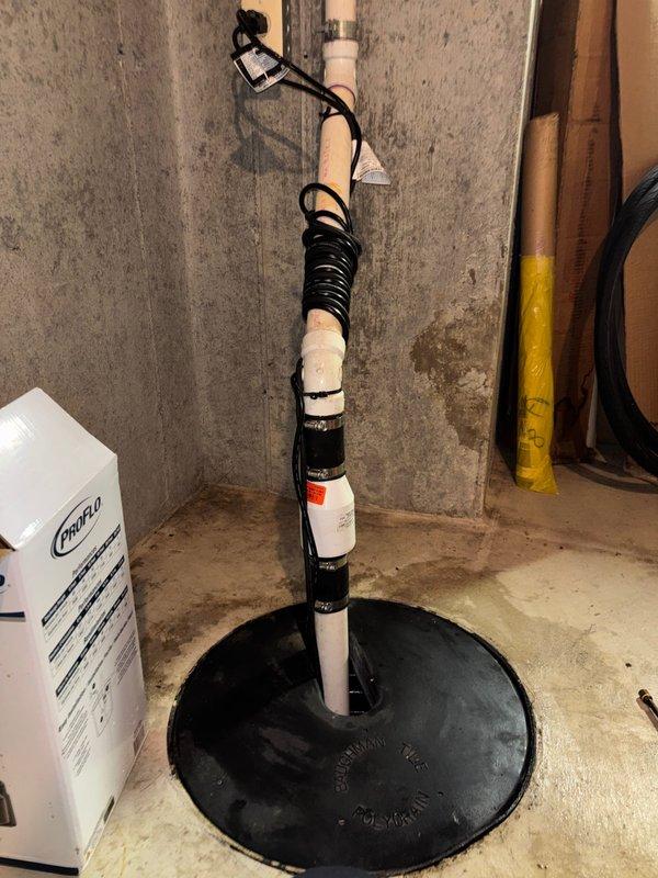 Replaced aging sump pump in 1993-built home, removing significant fibrous debris buildup from the sump pit that was causing drainage issues. Installed new pump with proper PVC discharge piping and electrical connections, ensuring system functionality in an area showing signs of previous moisture accumulation.
