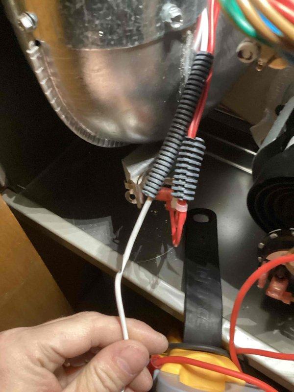 Repaired Carrier furnace that was not heating to temperature by reconnecting loose wire connections to the limit switch circuit. Identified disconnected white wire with spring coil connectors that had detached from terminal, restoring proper electrical continuity to the system. Unit now heating properly and operating within normal parameters.