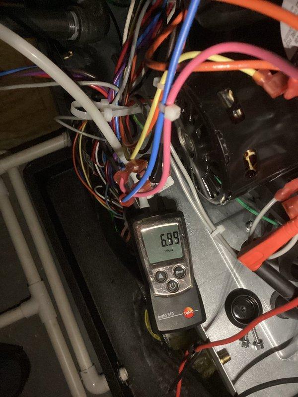 Performed diagnostic testing on one-year-old EnergiAir furnace that was running but not producing adequate heat. Conducted electrical measurements using Testo instrument, checking voltage readings (6.99V) at control module connections. Inspected blower motor assembly and verified proper wiring connections to resolve heating efficiency issue. Completed annual tune-up as part of service.