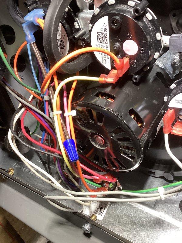 Performed diagnostic testing on one-year-old EnergiAir furnace that was running but not producing adequate heat. Conducted electrical measurements using Testo instrument, checking voltage readings (6.99V) at control module connections. Inspected blower motor assembly and verified proper wiring connections to resolve heating efficiency issue. Completed annual tune-up as part of service.