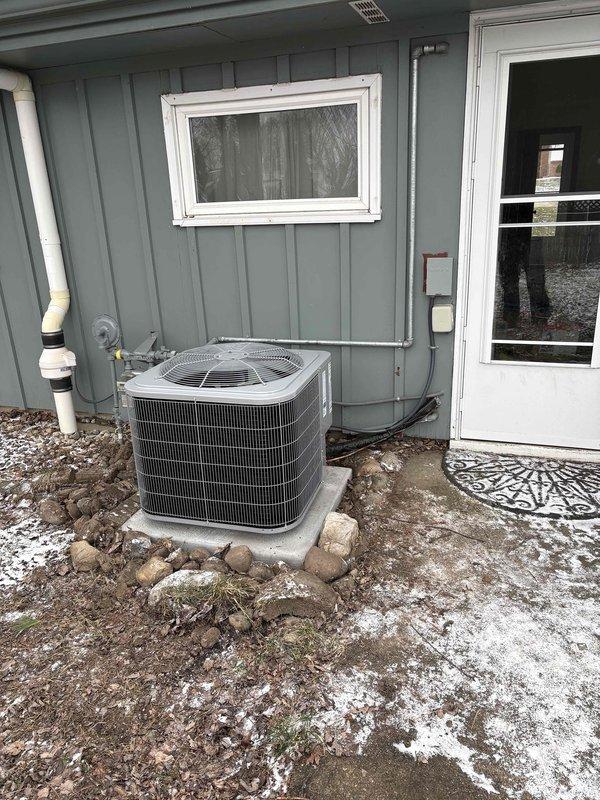Successfully completed installation of a new Carrier furnace and AC system. The outdoor condenser was properly placed on a concrete pad with appropriate electrical conduit and refrigerant line connections. Indoor furnace unit was installed with proper ductwork connections and all required safety labels in place.