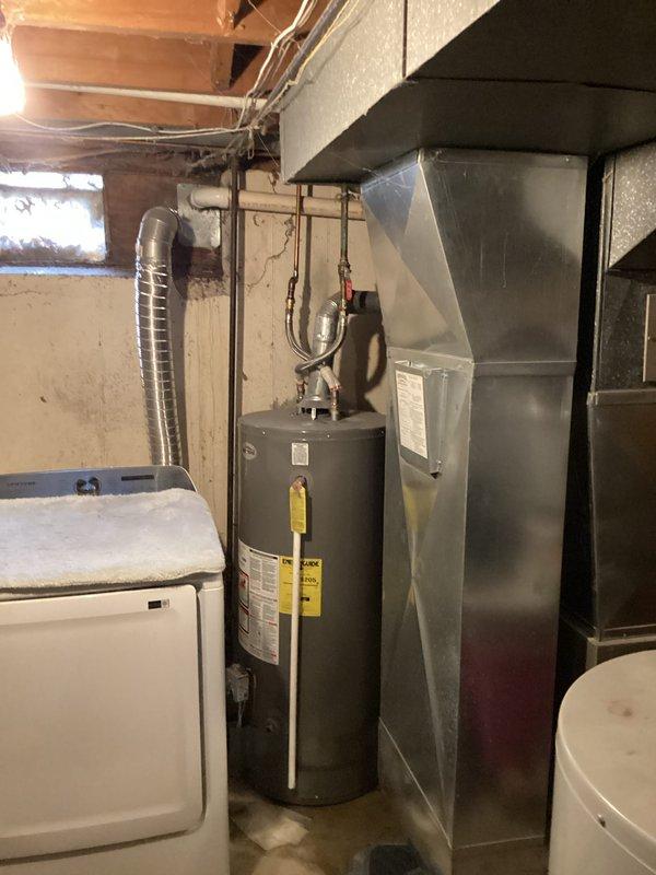 Responded to water leak service call for a 5-year-old water heater exhibiting active leakage with visible puddle formation. Upon inspection, documented the condition of the unit and surrounding utility area. Completed necessary repairs to address the water leak and performed requested tune-up service on the system.