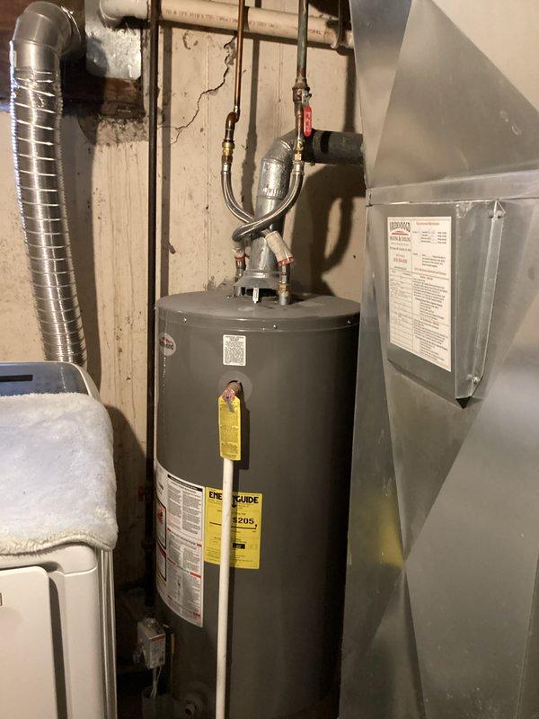 Responded to water leak service call for a 5-year-old water heater exhibiting active leakage with visible puddle formation. Upon inspection, documented the condition of the unit and surrounding utility area. Completed necessary repairs to address the water leak and performed requested tune-up service on the system.
