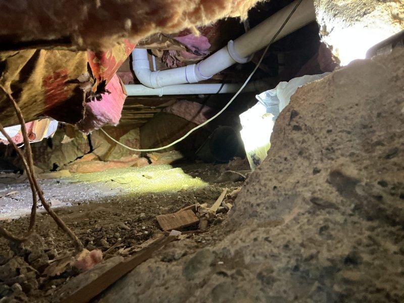 Successfully completed the basement drain repipe installation, replacing the existing drainage system with new PVC piping. Work included installing horizontal runs with proper elbow joints in the crawlspace beneath the floor, navigating around existing electrical wiring and insulation. The basement utility area repipe has been completed, with all connections properly secured and tested.