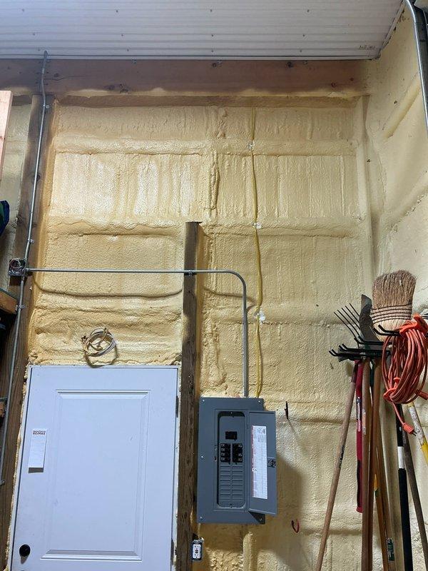 Conducted site assessment for mini-split installation in a 16' x 40' x 14' insulated pole barn. Inspected electrical panel capacity and documented spray foam insulation throughout the structure. Evaluated exterior wall conditions for potential condenser placement, noting metal corrugated siding and surrounding environmental factors.