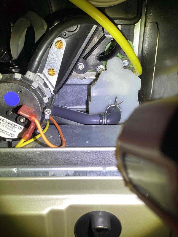 Completed annual heating maintenance on customer's furnace system. Inspected interior components including condensate collection reservoir, wiring connections, and motor assembly. No humidifier present; system appears to be functioning properly with all components in good working order.