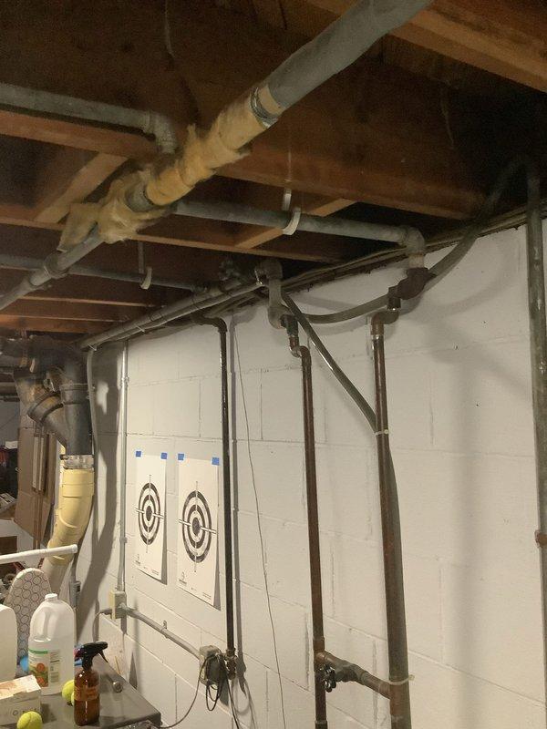 Conducted an on-site assessment of residential property for water softener installation quote. Inspected basement utility area with exposed plumbing infrastructure, documenting current water system configuration and available space for new equipment. Photos taken of installation area show proximity to existing laundry appliances and mechanical systems for proper integration planning.