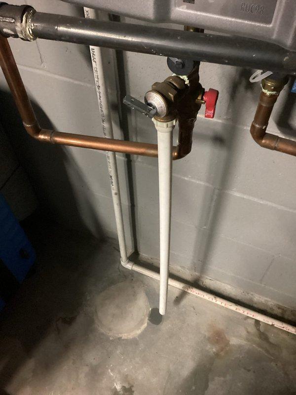 Inspected 12+ year old Ruud tankless water heater experiencing intermittent hot water failure, particularly during evening usage. Discovered mineral buildup in heat exchanger and partially clogged inlet filter restricting water flow. Performed comprehensive descaling service and cleaned filter assembly to restore proper operation and heat transfer efficiency.