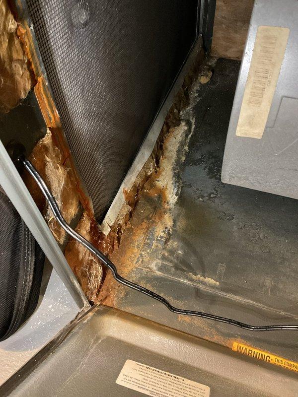 Performed annual heating maintenance on 16-year-old ENERGI furnace. Inspection revealed significant rust/corrosion on interior components and deteriorating insulation. Blower assembly and electrical connections appear to be in functional condition despite the unit's age.