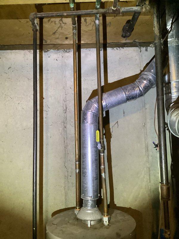 Responded to no-heat call for 10-year-old Ruud system that was turning on briefly before shutting off. Inspection of the furnace and water heater installation in basement utility room revealed proper venting configuration with no visible issues. Verified all connections to ensure proper ventilation of combustion gases. System was restored to normal operation.