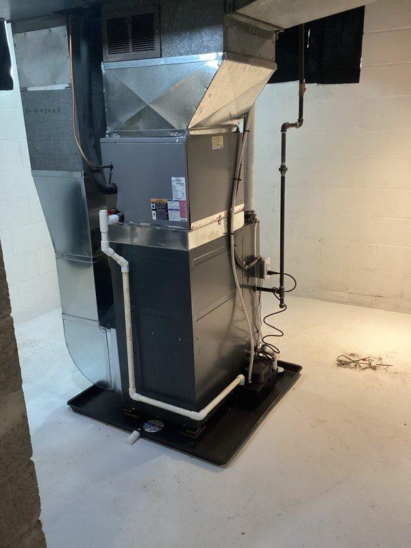 Successfully completed installation of new furnace and water heater in basement utility room. New furnace was properly mounted on black base pad with all required PVC venting, copper lines, and electrical connections installed to code. System was tested for proper operation with all connections secure and labeled.