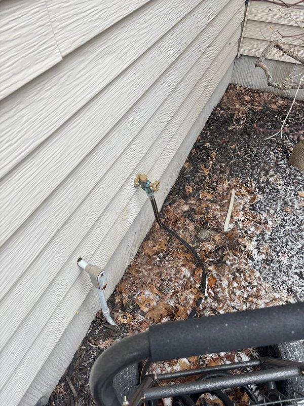 Successfully repaired exterior hose bib that had been leaking due to freeze damage from winter exposure with attached hose. Inspected interior PVC supply line connections in basement to ensure proper operation and no additional leaks.