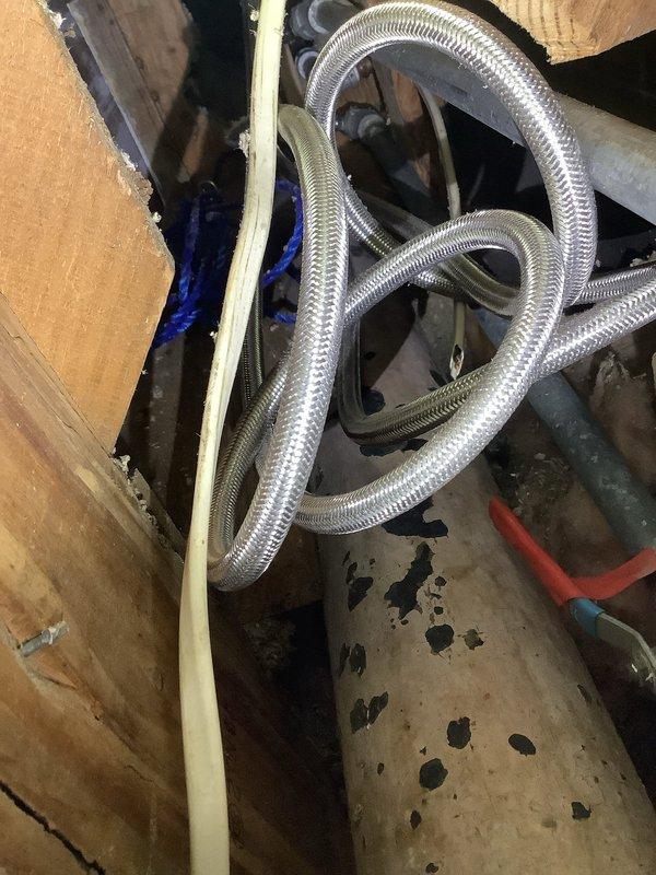 Inspected plumbing system for lack of hot water supply to shower. Identified issue with flexible braided supply line that was kinked and restricted flow. Replaced damaged supply line and flushed water heater to remove sediment buildup. Verified proper hot water flow to shower after repairs were completed.