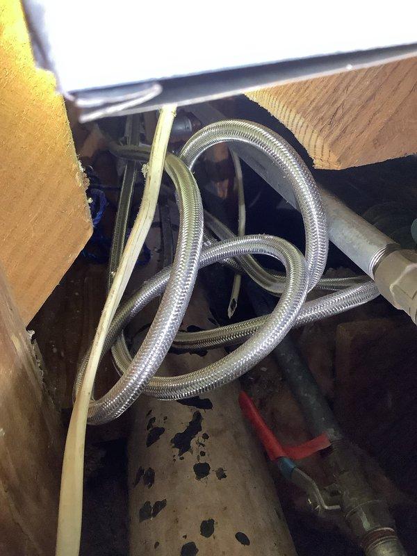 Inspected plumbing system for lack of hot water supply to shower. Identified issue with flexible braided supply line that was kinked and restricted flow. Replaced damaged supply line and flushed water heater to remove sediment buildup. Verified proper hot water flow to shower after repairs were completed.