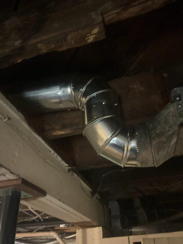Completed inspection of exposed HVAC ductwork in unfinished ceiling area. Examined galvanized metal ducting system including elbow joints, connections to main trunk lines, and mounting to wooden joists. Also inspected adjacent PVC plumbing pipes and electrical cables for potential interference issues.