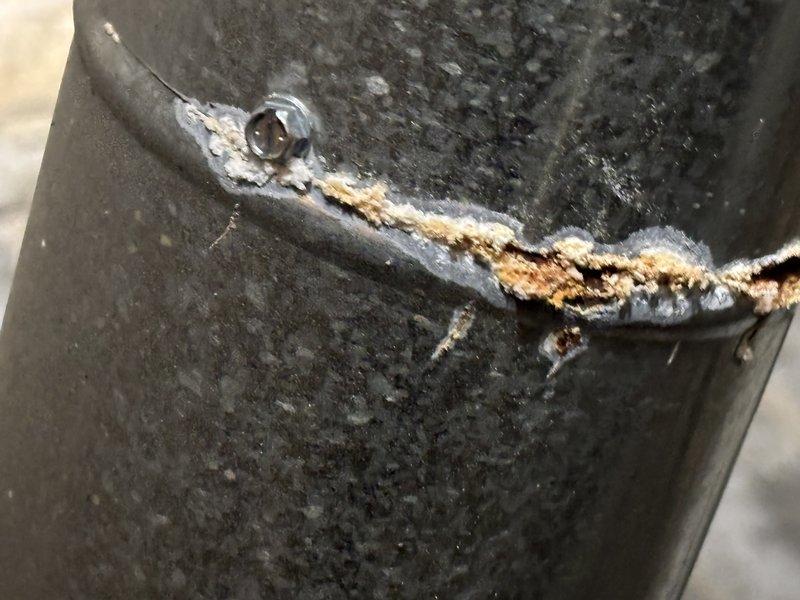 Responded to service call for a 9-year-old heating system that was cutting out intermittently and eventually stopped heating and blowing completely. Inspection revealed significant corrosion and rust formation at pipe joints in the system, with visible deterioration around connection points and a compromised welded seam showing potential leakage. Documented extensive metal deterioration with photographic evidence for comprehensive repair planning.
