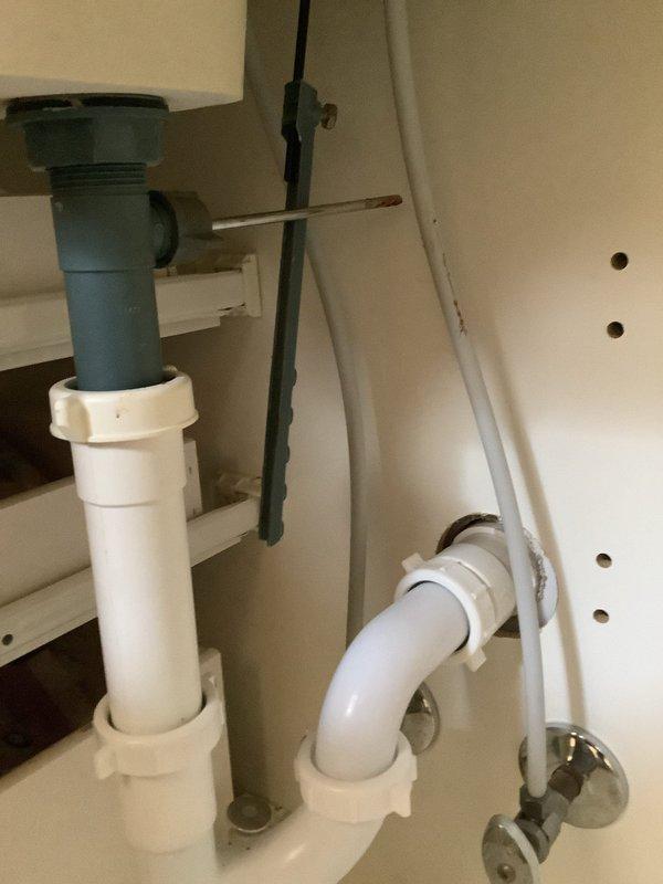 Diagnosed and replaced damaged sink pop-up stopper assembly that was exhibiting significant corrosion and deterioration at connection points. Removed the compromised component, installed new stopper mechanism, and verified proper drainage operation and seal function.