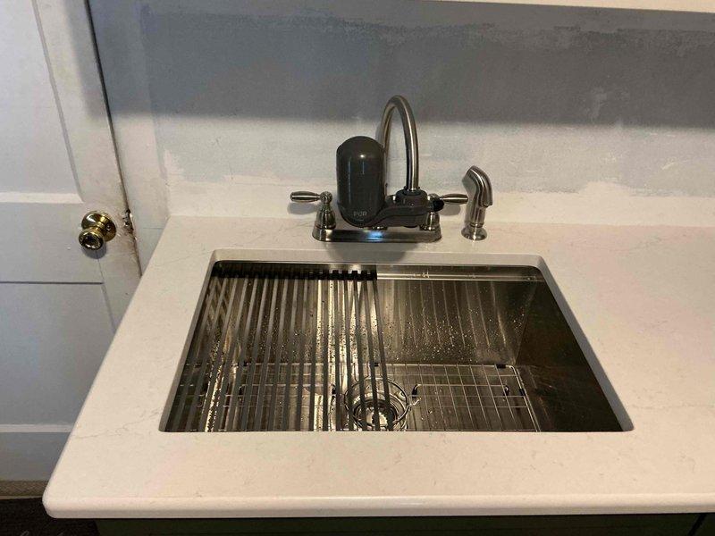 Returned to site for scheduled follow-up visit to complete sink installation. Successfully connected plumbing to the newly installed stainless steel kitchen sink with integrated filtration system. Final inspection confirmed proper water flow and no leaks at connection points.