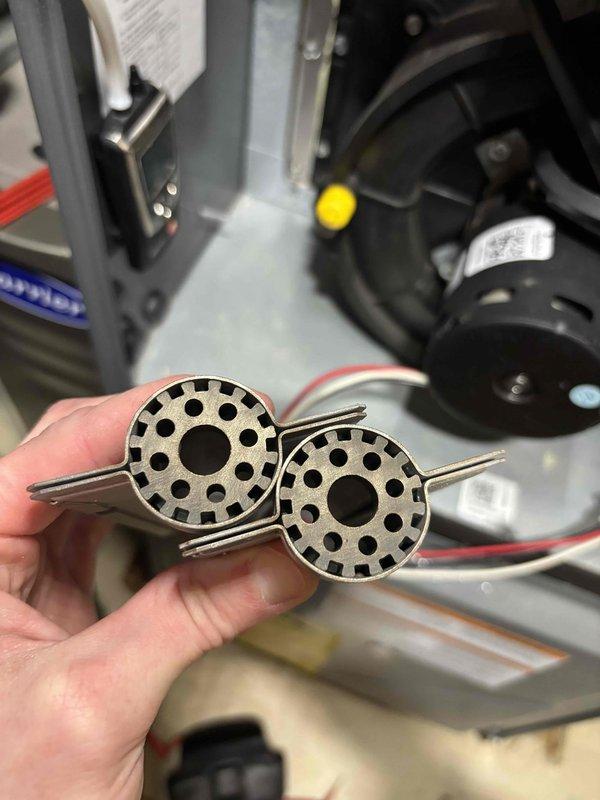 Completed annual heating maintenance on a 14-year-old Energi furnace. Inspected and cleaned the blower wheel assembly which showed minor dust accumulation. Examined heat exchanger port for proper operation with no signs of cracks or significant corrosion detected.