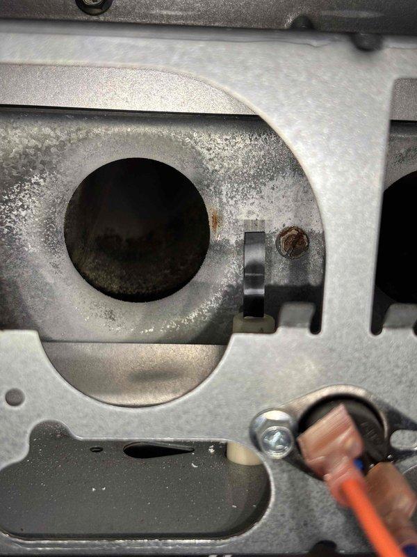 Completed annual heating maintenance on a 14-year-old Energi furnace. Inspected and cleaned the blower wheel assembly which showed minor dust accumulation. Examined heat exchanger port for proper operation with no signs of cracks or significant corrosion detected.