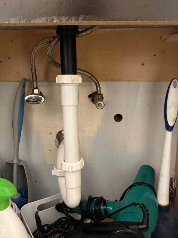 Responded to service call for bathroom drain clog that had been occurring for six months in a 60-year-old home. Performed diagnostic assessment of the plumbing system, identifying the blockage in the PVC P-trap assembly under the sink. Successfully cleared the obstruction and verified proper drainage function before completing the service.