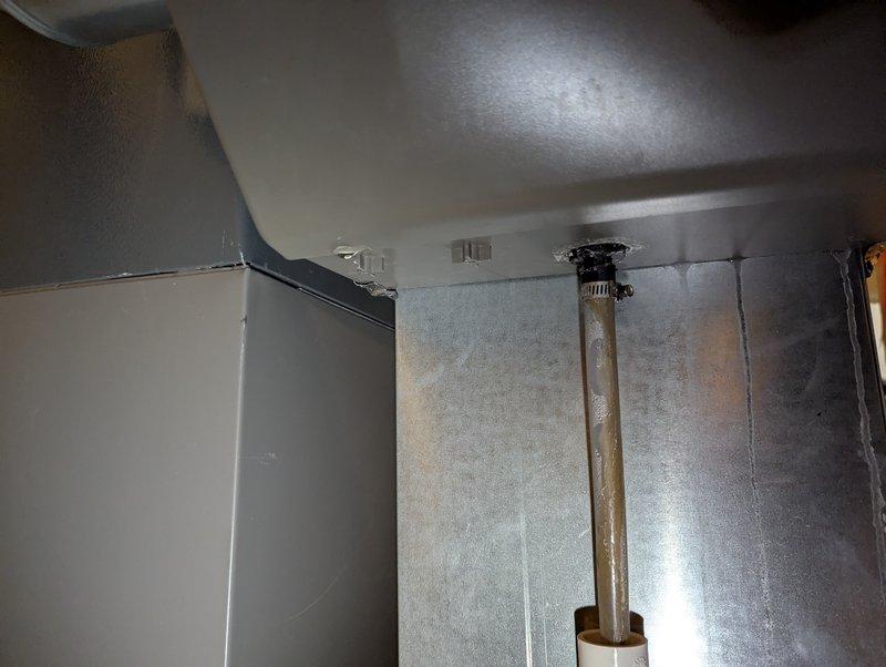 Responded to service call for leaking furnace humidifier in 7-year-old Lennox system. Discovered severely clogged evaporator pad causing water overflow, with temporary collection bucket in place. Replaced humidifier pad, cleaned unit, and verified proper operation with no further leakage.