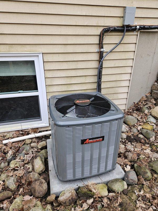 Successfully completed installation of new Amana air conditioning system, including outdoor condenser unit placed on concrete pad with proper line connections to the home. Interior work included connection to existing furnace system with appropriate ductwork modifications and PVC venting. All components were tested for proper operation and photo documentation was taken of both exterior and interior installations.