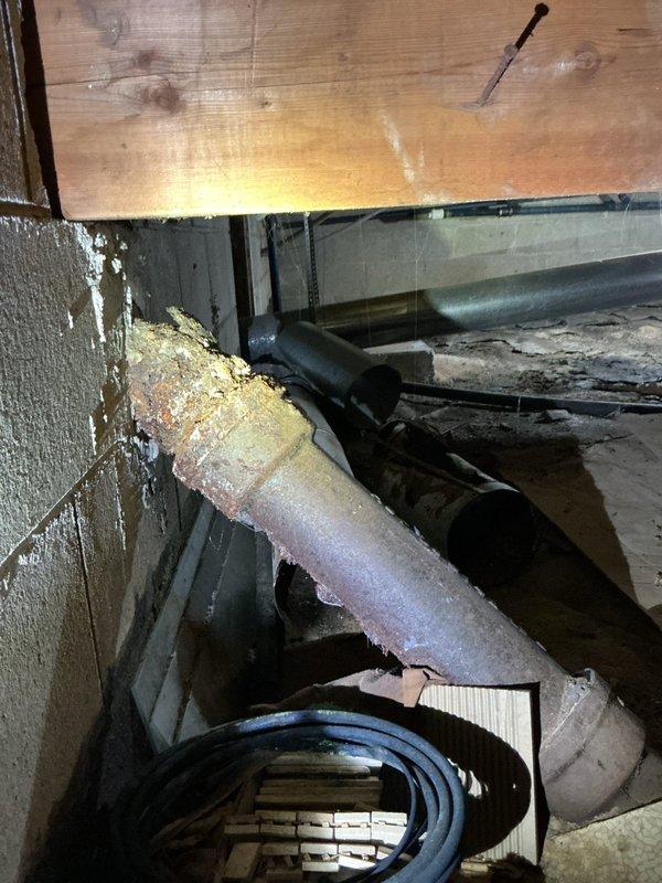 Identified and repaired a significant leak in the crawl space originating from severely corroded cast iron drain pipes that were causing water accumulation and odor issues. Replaced deteriorated sections with new PVC piping, properly sealed all connections, and verified system integrity with pressure testing to ensure complete resolution of the drainage problem.