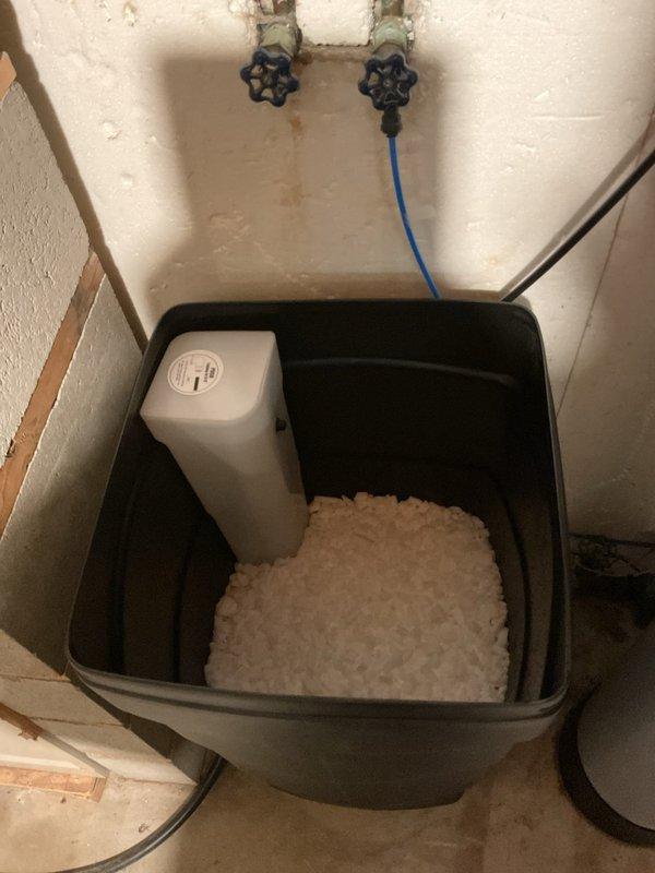 Successfully installed a Sterling High Efficiency water softener system with complete copper pipe integration in client's utility area. System was properly configured with digital control panel and connected to existing plumbing with all necessary valves. Salt tank was filled with appropriate media and system was tested to ensure proper function for the client's medical requirements.