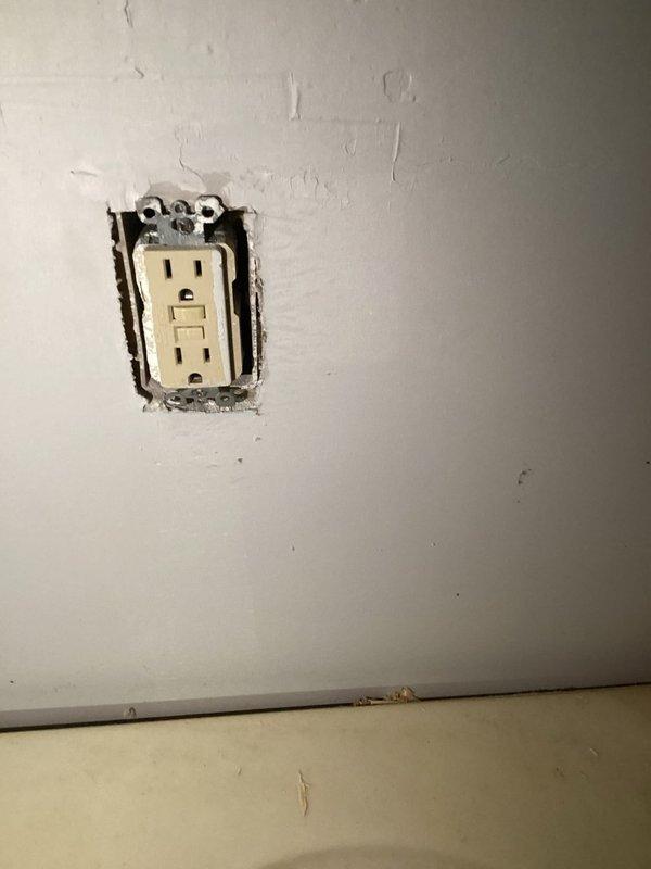 Completed inspection corrections per CWOW requirements. Verified proper installation of GFCI outlet, though observed rough drywall cuts around electrical box requiring further finishing. Inspected exterior disconnect box with proper line connections and confirmed proper operation of disconnect switch for HVAC equipment.