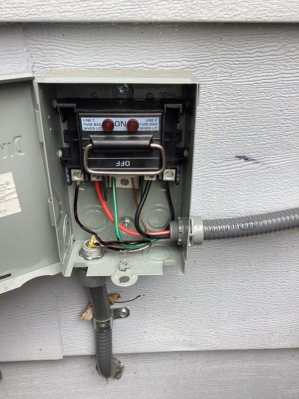 Completed inspection corrections per CWOW requirements. Verified proper installation of GFCI outlet, though observed rough drywall cuts around electrical box requiring further finishing. Inspected exterior disconnect box with proper line connections and confirmed proper operation of disconnect switch for HVAC equipment.