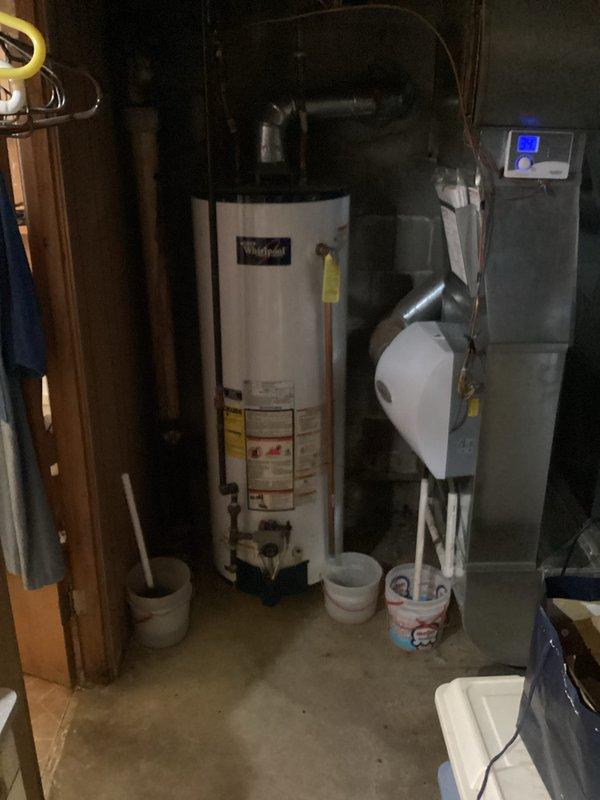 Responded to no-heat call for an 11-year-old EnergiAir furnace that was not operational. Upon inspection, diagnosed system issues and restored heating functionality. Documented the repair with photos of the furnace installation area, which includes a Whirlpool water heater and associated plumbing components.
