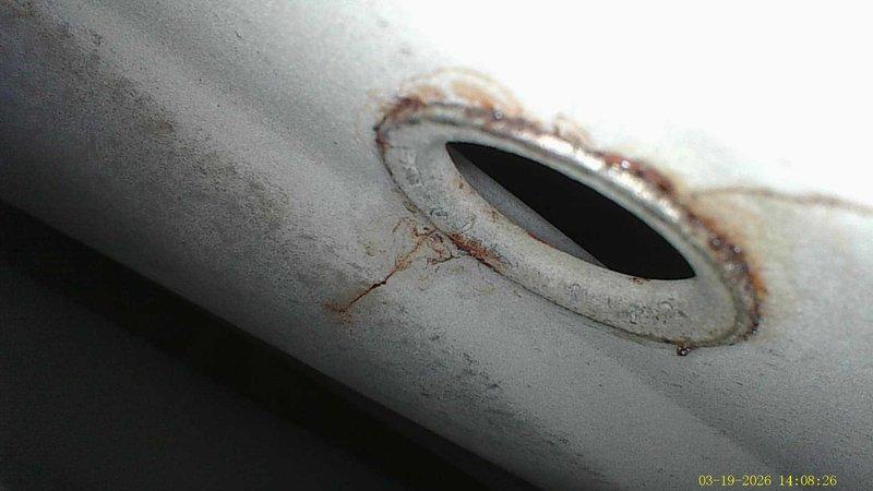 Responded to no heat call where system was blowing cold air. Diagnosed significant water damage and corrosion on heat exchanger with visible rust formation around exhaust openings. Determined unit requires heat exchanger replacement due to compromised integrity and safety concerns.