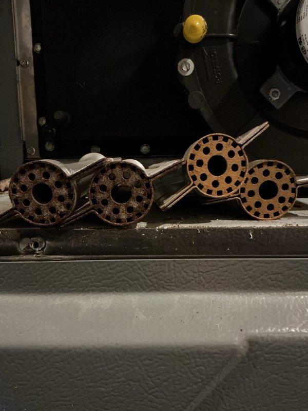 Performed annual heating maintenance on 14-year-old Amana furnace, including inspection and cleaning of burner assemblies which showed oxidation. Drained and cleaned condensate pan which contained significant debris and sediment buildup, ensuring proper drainage function.