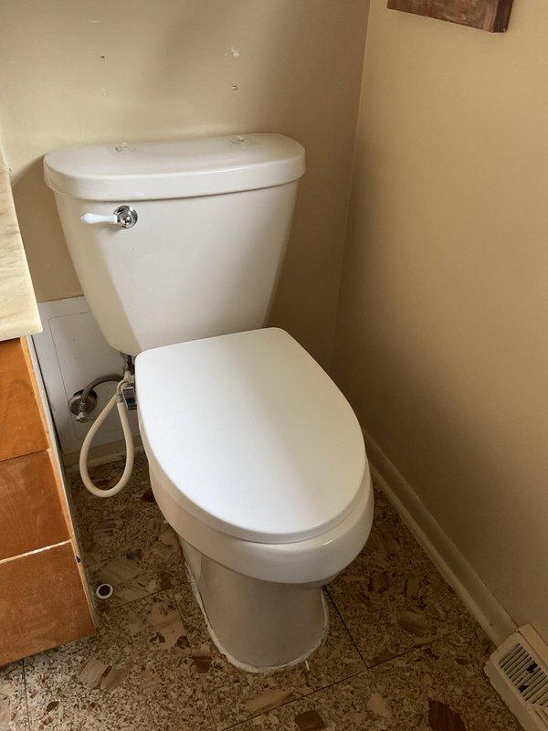 Completed quoted toilet replacement for customer. Removed old toilet and installed new standard white toilet with proper water supply connection. Noted significant floor damage around toilet area with deteriorated vinyl flooring that will require separate repair.