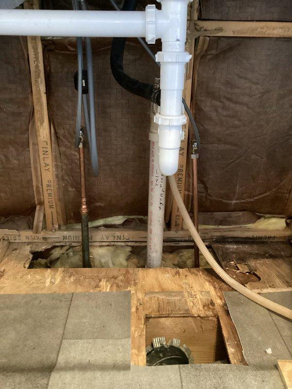 Completed 4 hours of kitchen rough-in plumbing work, installing PVC drainage system with multiple joints and connections. Installed copper supply lines between floor joists and verified proper P-trap configuration for kitchen fixtures. Will return to complete remaining kitchen plumbing installation.