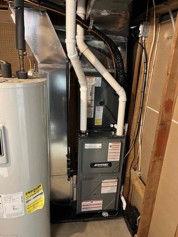 Successfully completed installation of new ENERGY furnace system with matching AC unit in residential basement. System includes proper PVC intake/exhaust venting, connected ductwork with appropriate transitions, and integrated humidifier mounted to air handler. All components were properly secured, connected, and verified operational before completion.