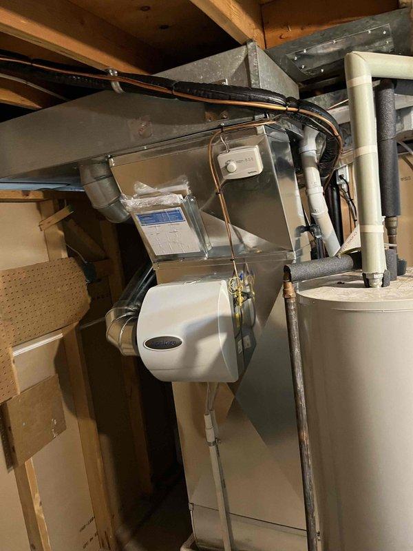 Successfully completed installation of new ENERGY furnace system with matching AC unit in residential basement. System includes proper PVC intake/exhaust venting, connected ductwork with appropriate transitions, and integrated humidifier mounted to air handler. All components were properly secured, connected, and verified operational before completion.
