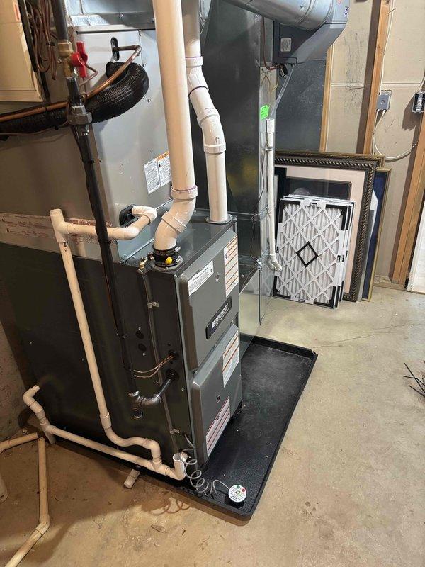 Successfully completed installation of new Goodman furnace unit in basement utility room, including proper mounting on drip pan, connection of PVC drainage/ventilation pipes, and integration with existing ductwork. System was fully tested with filter properly installed and all warning labels affixed to ensure safe operation.