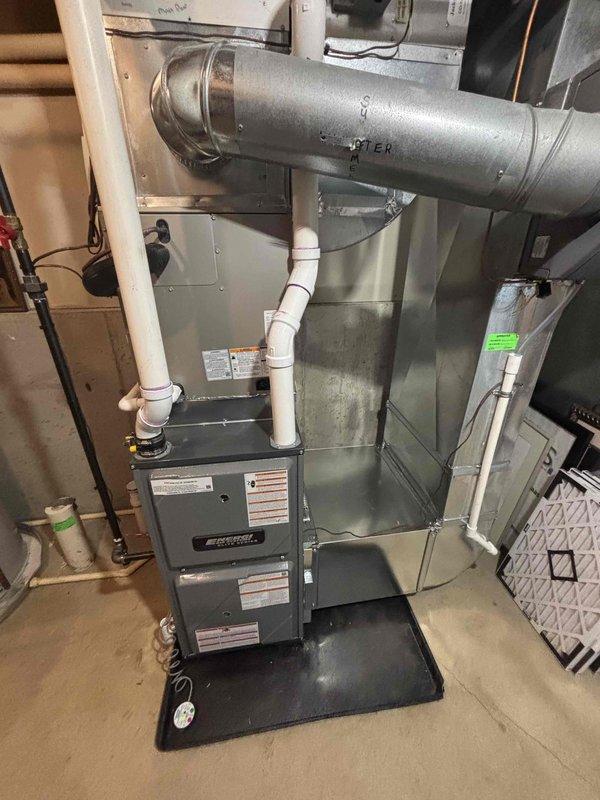 Successfully completed installation of new Goodman furnace unit in basement utility room, including proper mounting on drip pan, connection of PVC drainage/ventilation pipes, and integration with existing ductwork. System was fully tested with filter properly installed and all warning labels affixed to ensure safe operation.